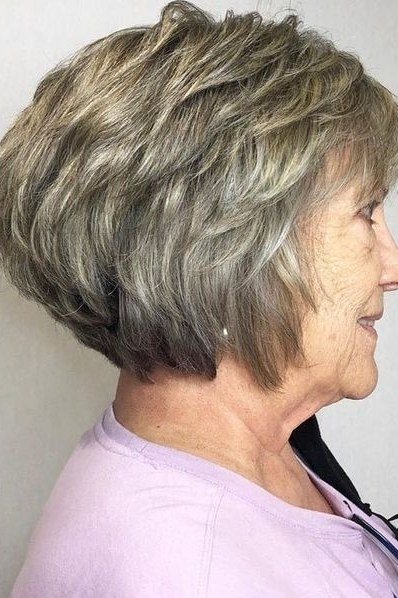 Silver layered wedge on a woman over 60, side view - wedge bob hairstyle