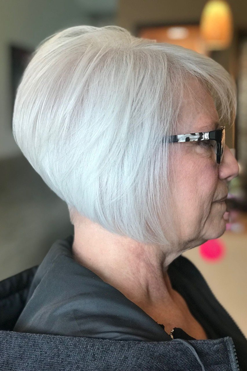 White wedge with glasses on a woman over 60, side view - wedge bob hairstyle