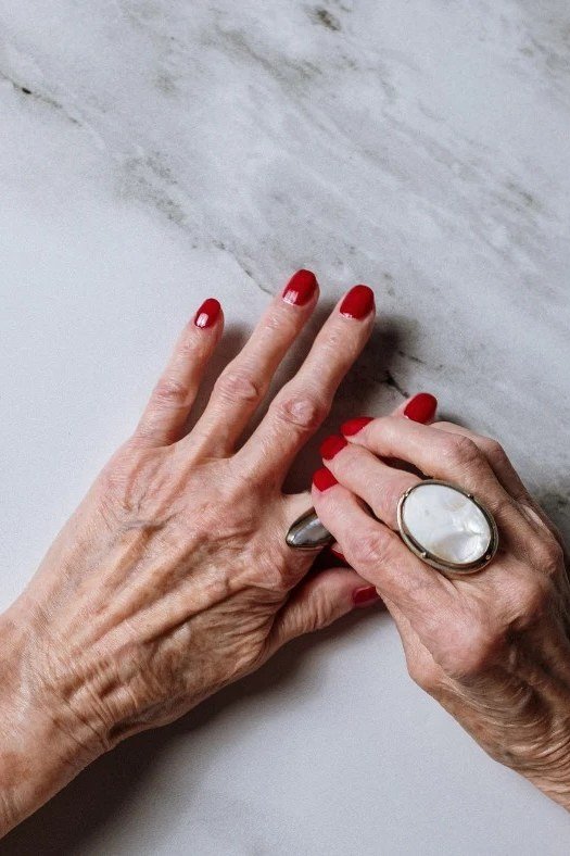 Bold Red with a Statement Ring, winter nail color idea for women over 60