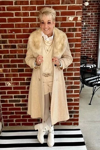 Cream Faux-Fur Coat on a Brick Porch winter outfit for women over 50