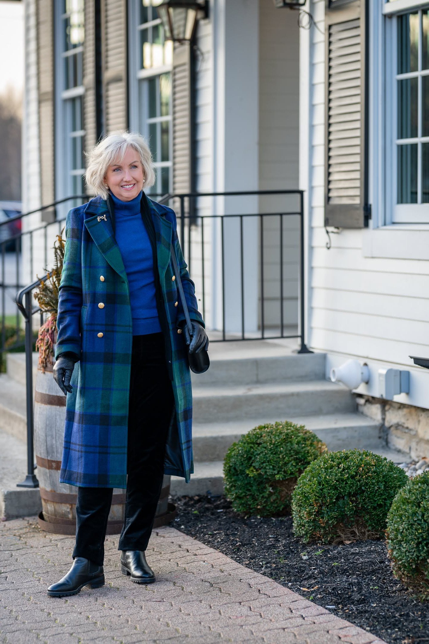 Winter outfit for women over 60: green-blue plaid coat, blue turtleneck, street