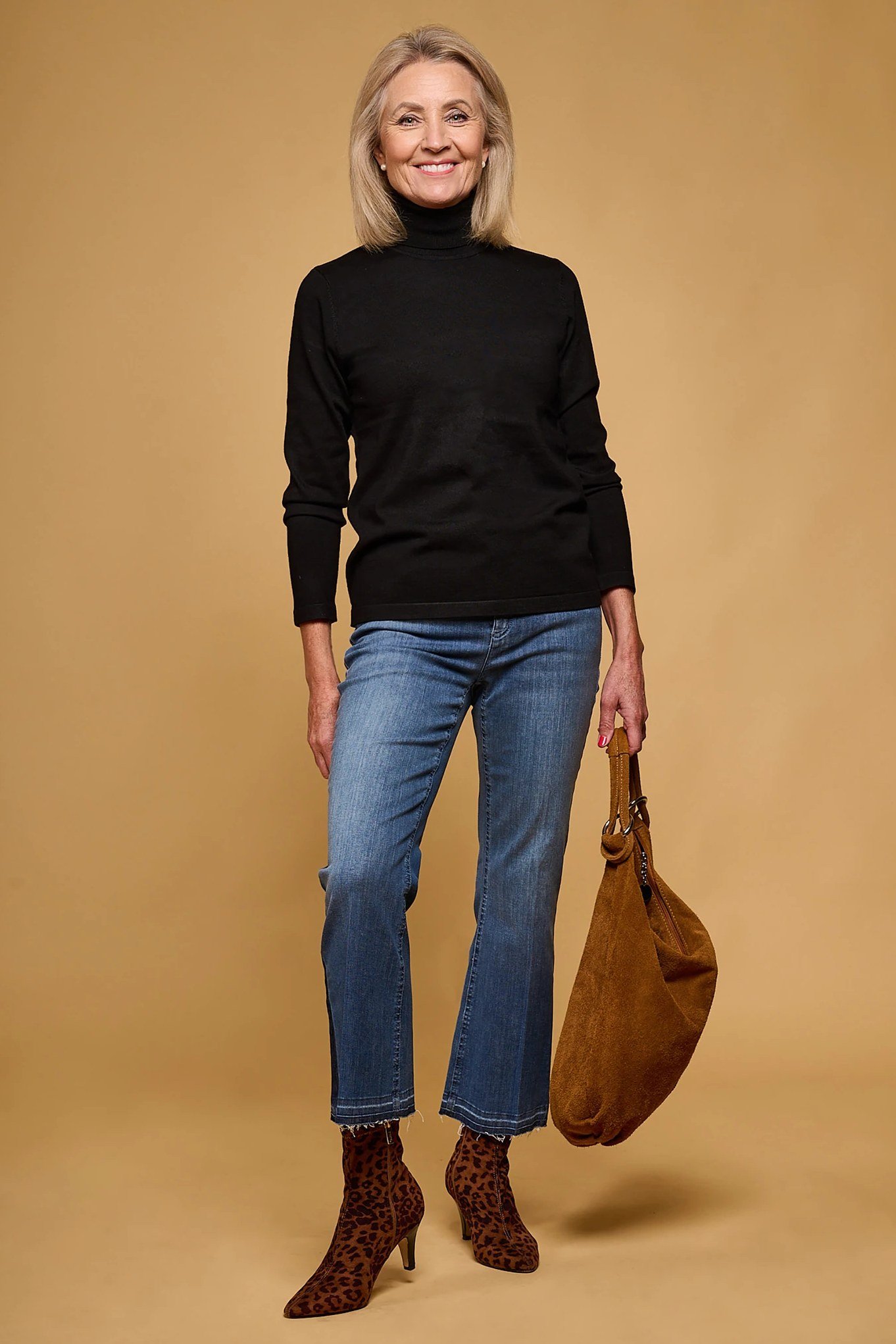 Black Turtleneck with Jeans and Tan Boots on a woman over 60, cozy winter casual outfit idea 3