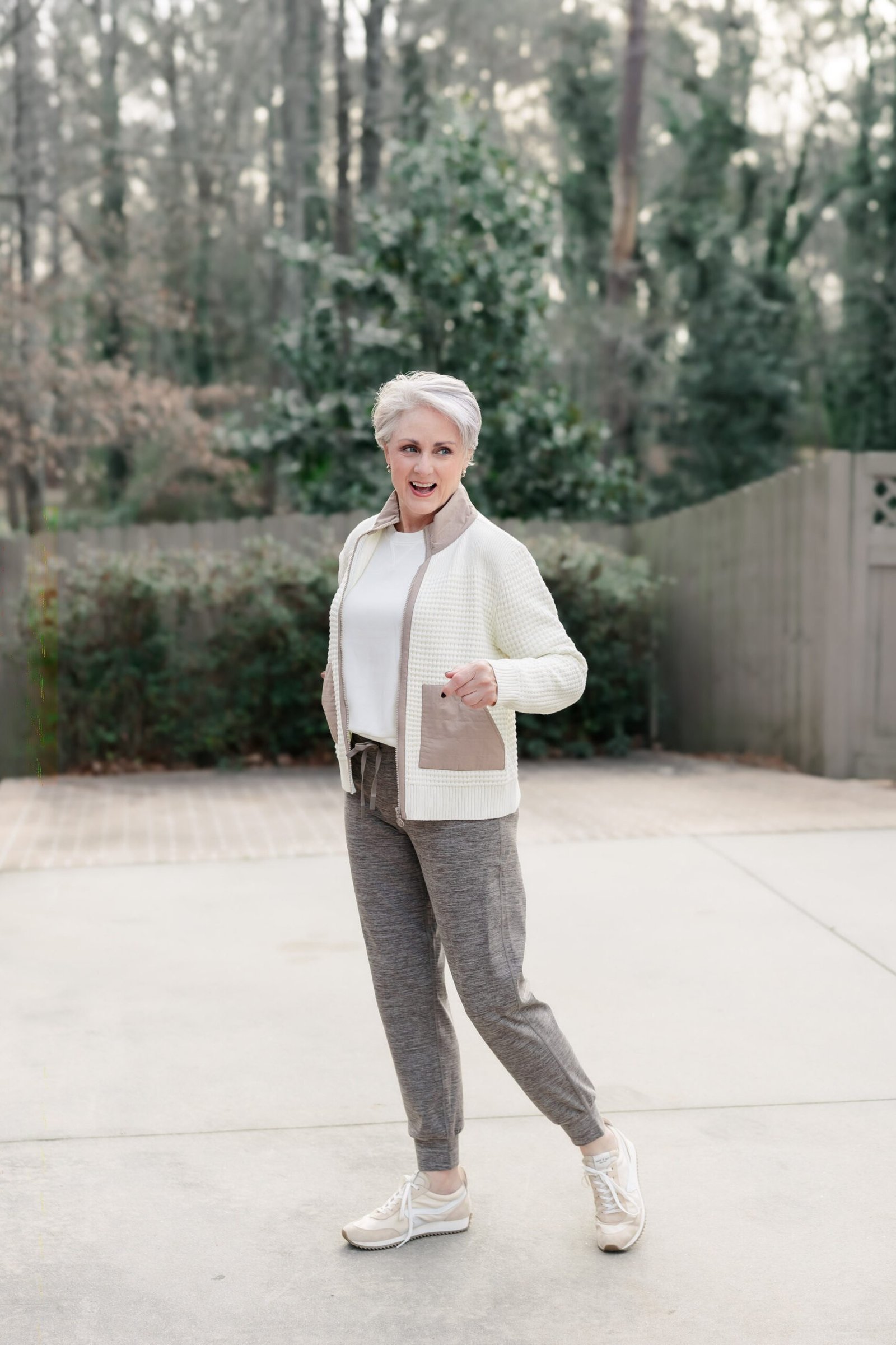 White Zip Jacket with Gray Joggers on a woman over 60, cozy winter casual outfit idea 20