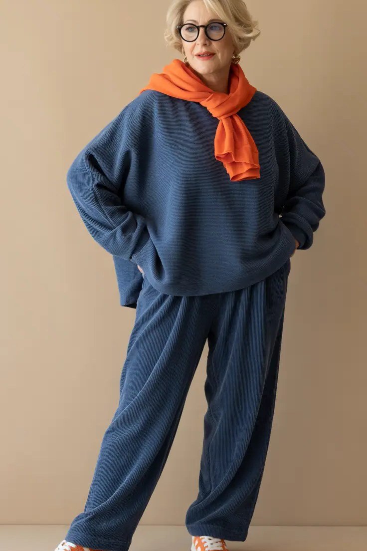 Navy Sweatshirt with Orange Scarf and Navy Pants on a woman over 60, cozy winter casual outfit idea 21