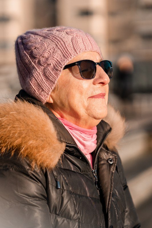 Mauve Beanie and Black Puffer with Fur Hood on a woman over 60, cozy winter casual outfit idea 31