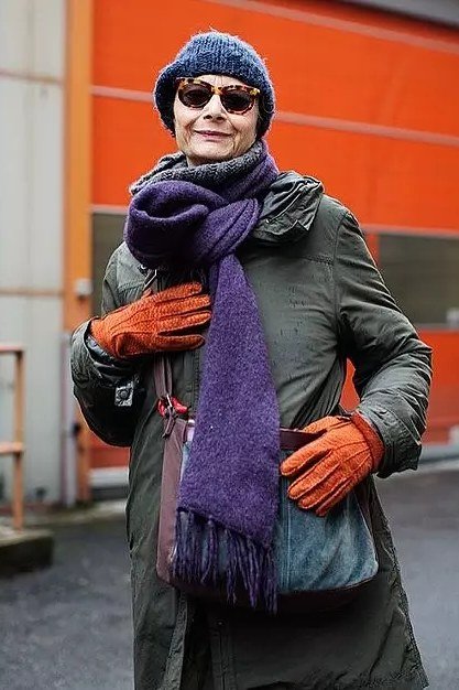 Olive Coat with Purple Scarf and Orange Gloves on a woman over 60, cozy winter casual outfit idea 38