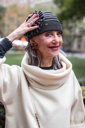 Cream Cowl-Neck Sweater with Dark Striped Beanie on a woman over 60, cozy winter casual outfit idea 55