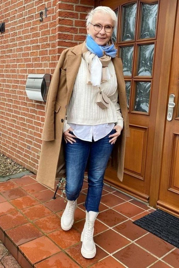 Camel Coat with Cream Sweater, Jeans, and White Boots on a woman over 60, cozy winter casual outfit idea 62