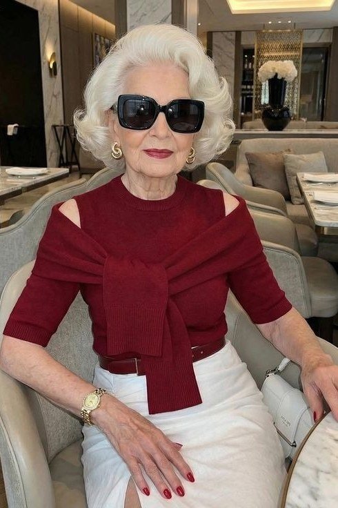 winter date night outfit for women over 60: red wrap top with white skirt in a restaurant