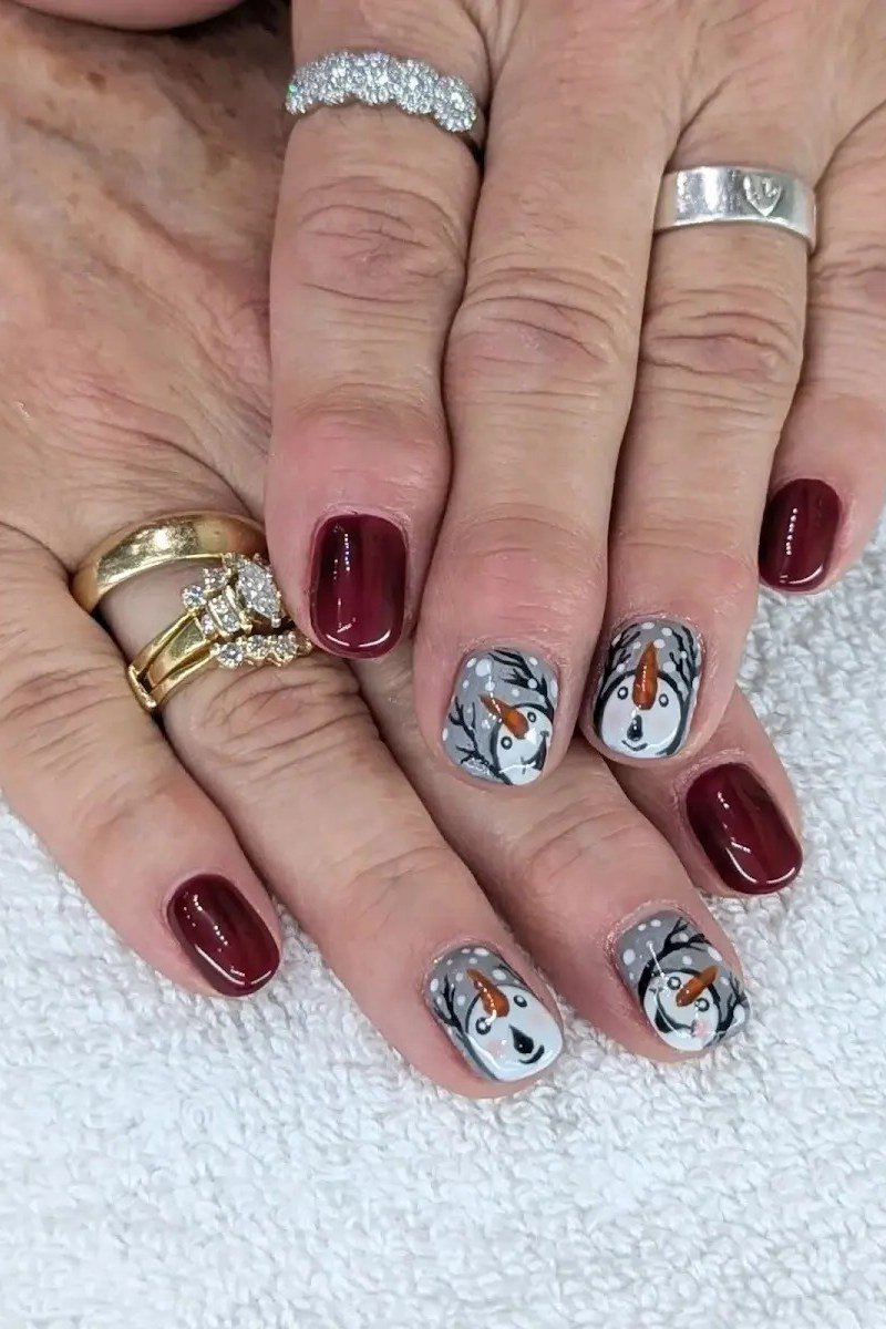 Navy Blue with Snowflake Accent - winter nail idea for women over 60
