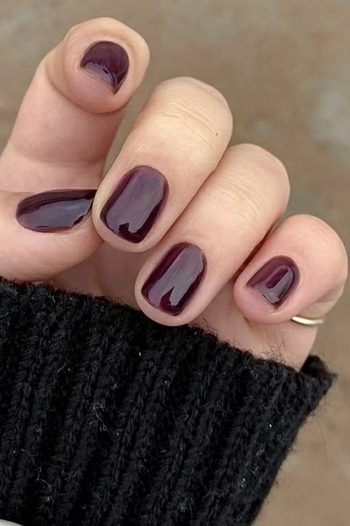 Glossy deep burgundy short winter nails for women over 60