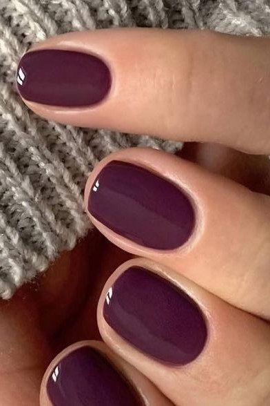 Rich plum glossy short winter nail color for older women