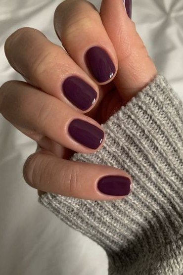 Dark plum glossy short nails for women over 60