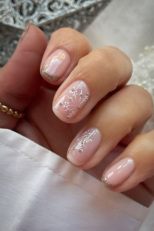 Sheer nude short winter nails with white snowflake art