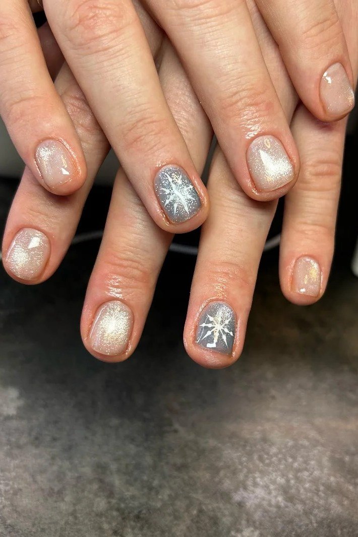 Champagne nails with silver snowflake art for winter