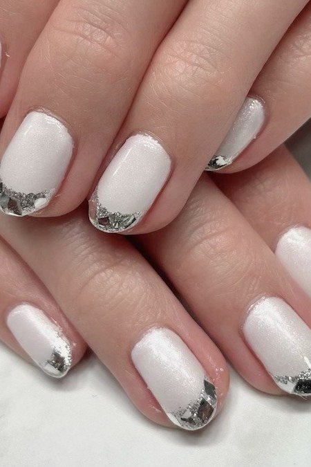 Milky white nails with silver glitter french tips