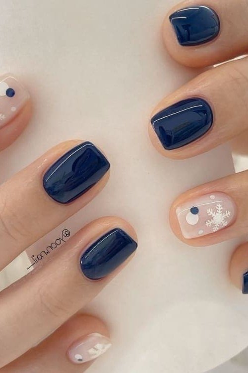 Navy blue short winter nails with snowflake and dot accents