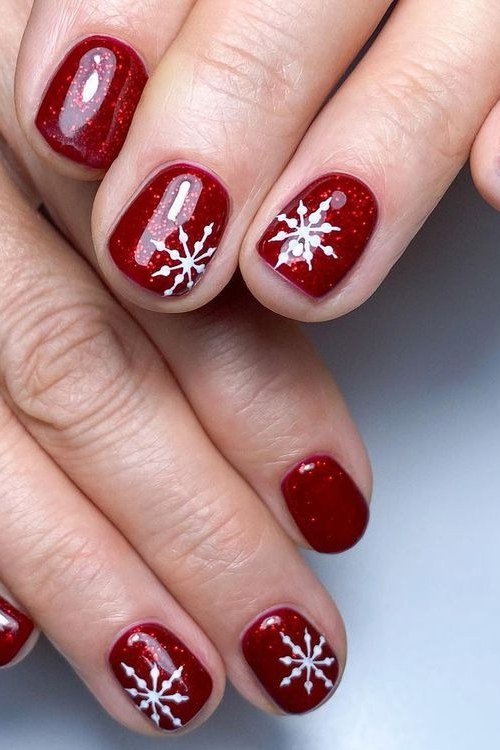 Red short winter nails with white snowflake art