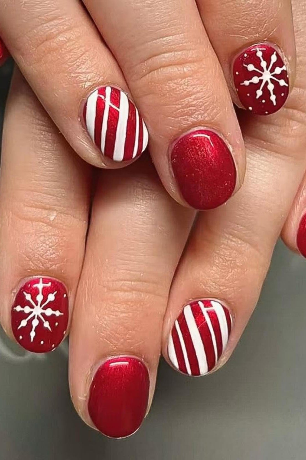Red short winter nails with candy cane and snowflake art