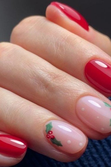 Red nails with holly berry nail art on nude accents