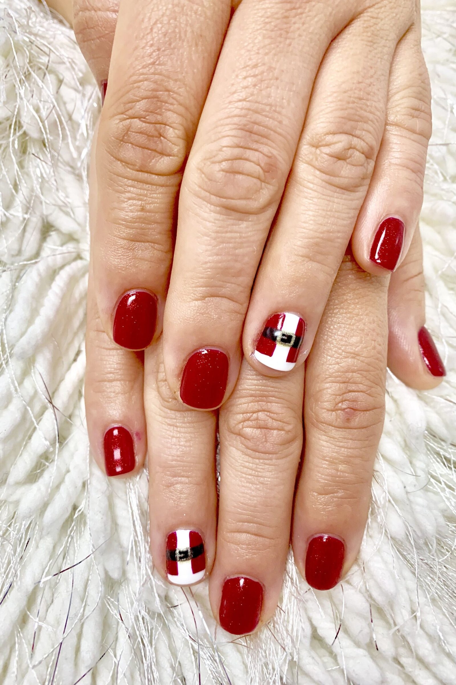Red short winter nails with santa belt accent nail