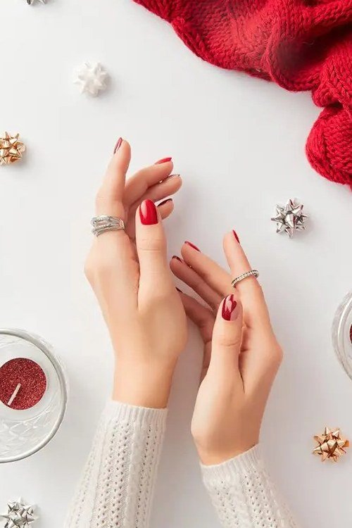Red Manicure Styled with Gold Decorations - timeless winter nail color for women over 60