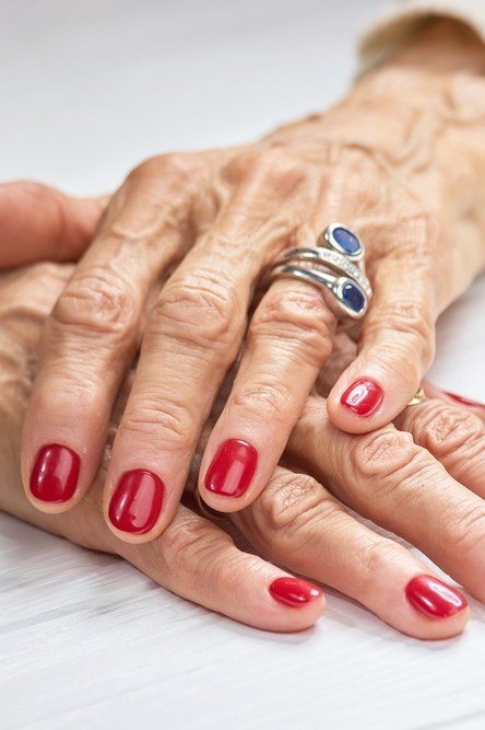 Classic Red Nails on Elegant Older Hands - timeless winter nail color for women over 60
