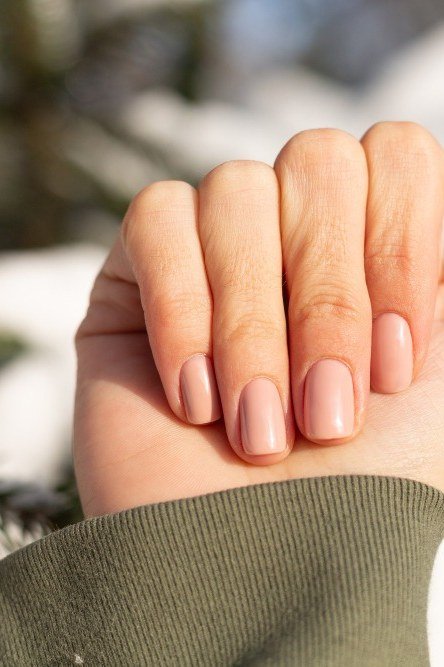 Nude Nails Against Fresh Snow - timeless winter nail color for women over 60