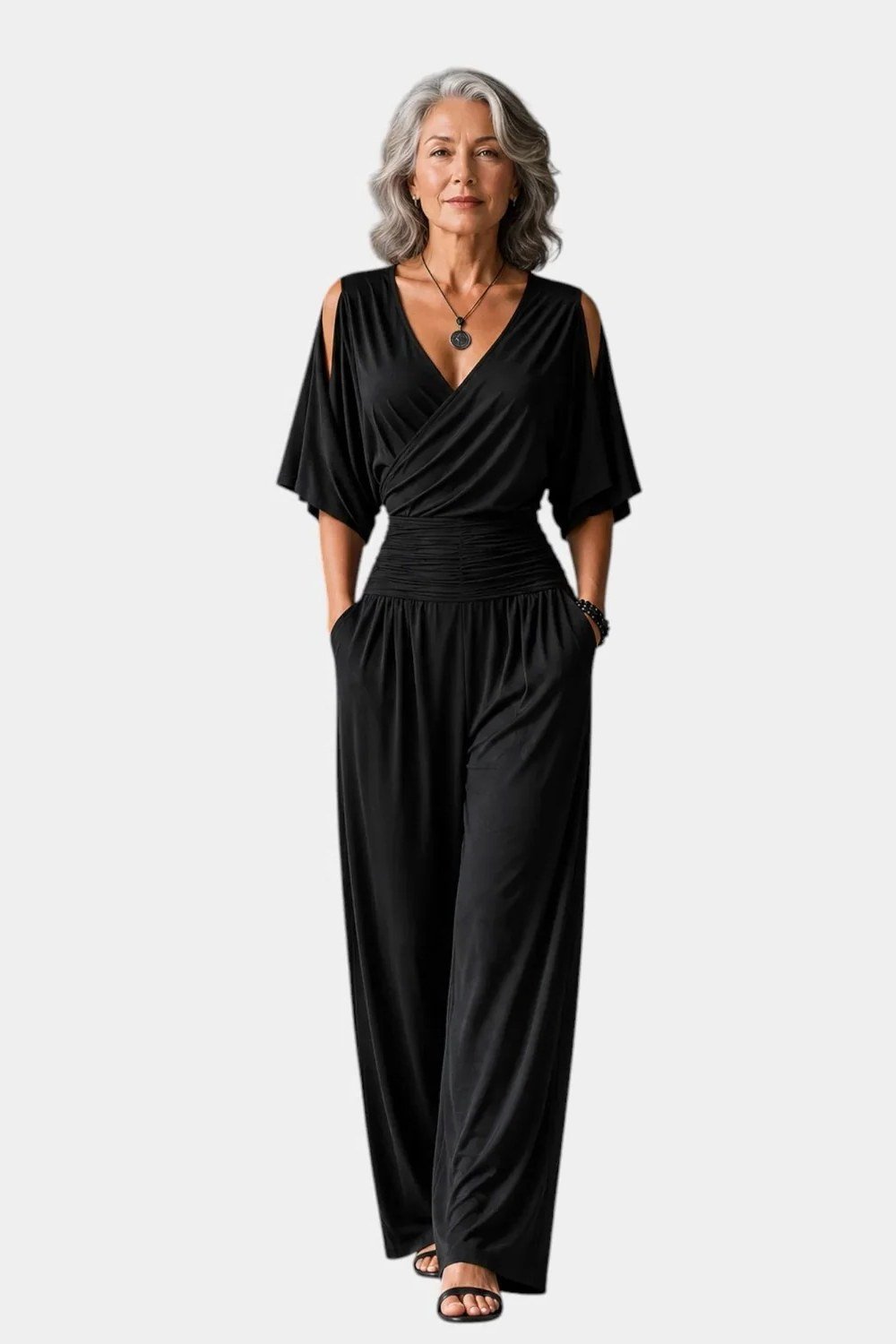 Woman in black wrap jumpsuit full body, timeless New Year's Eve jumpsuit for women over 60