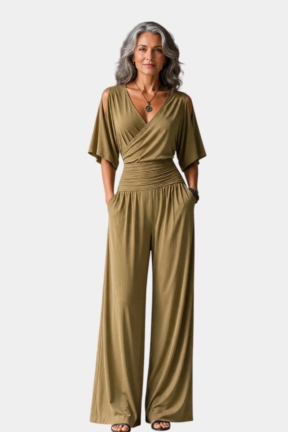 Gray-haired woman in olive-green wrap jumpsuit full body, sophisticated New Year's Eve jumpsuit for women over 60