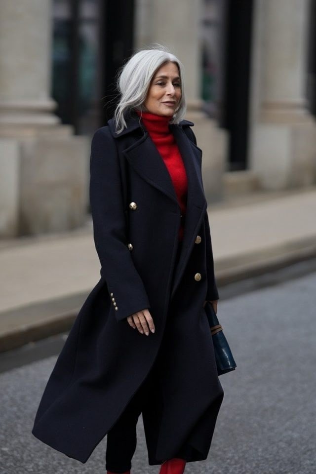 Navy double breasted coat over vivid red turtleneck, preppy winter color pop outfit for women over 60