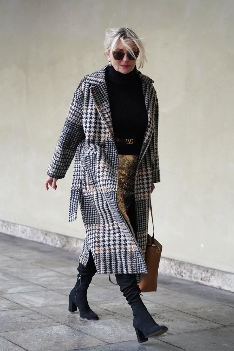 Black and white houndstooth plaid coat over black turtleneck with knee boots, statement winter coat outfit for older women