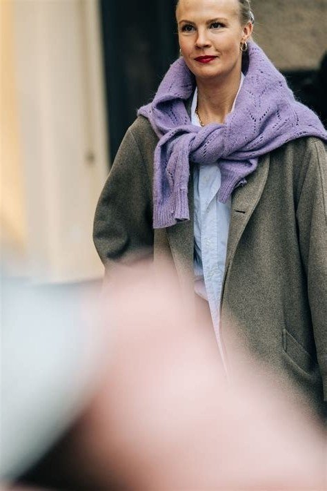 Olive green coat over light blue shirt with lavender knit scarf wrapped high, creative winter color outfit for women over 60