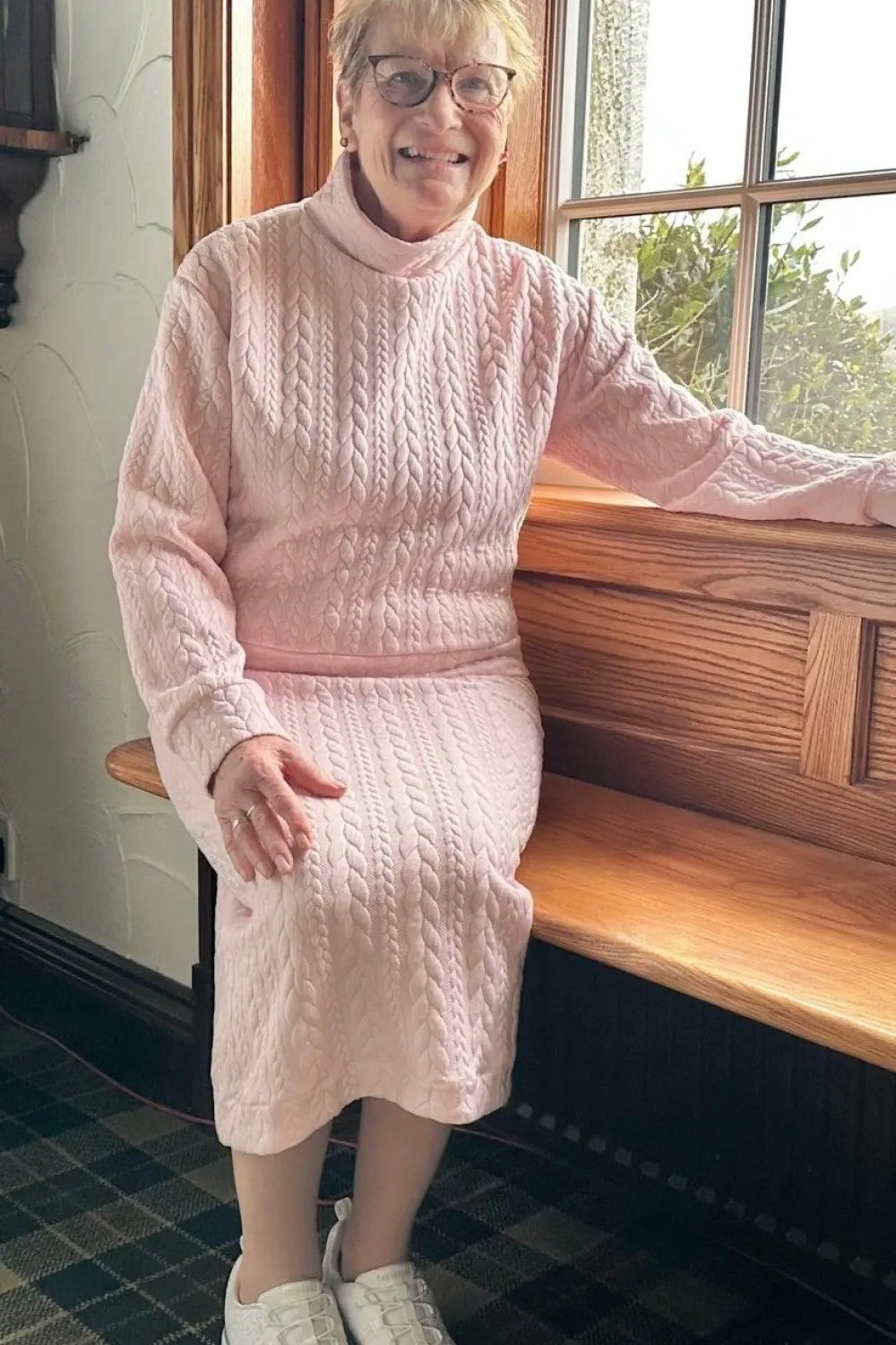Pink cable knit sweater and skirt set with white sneakers, cozy matching winter set for older women