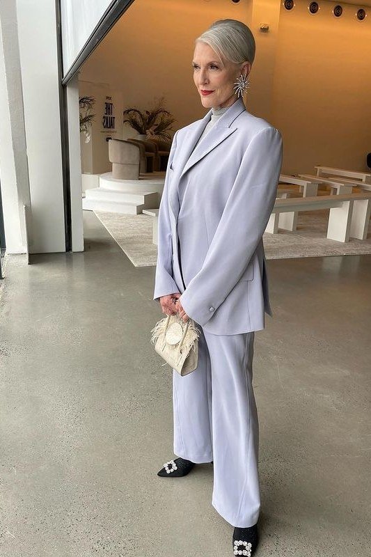 Woman in soft lavender suit in a modern interior
