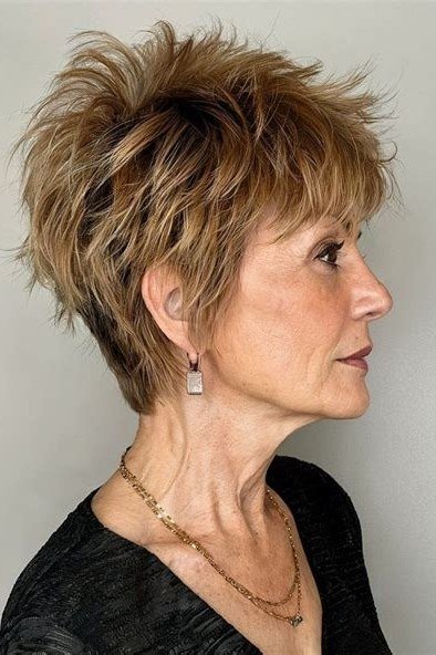 Short wolf cut for women over 60 - honey-blonde spiky wolf, black top, side view