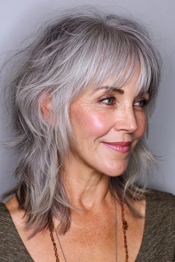 Short wolf cut for women over 60 - gray shaggy wolf, soft layers, olive top, side view