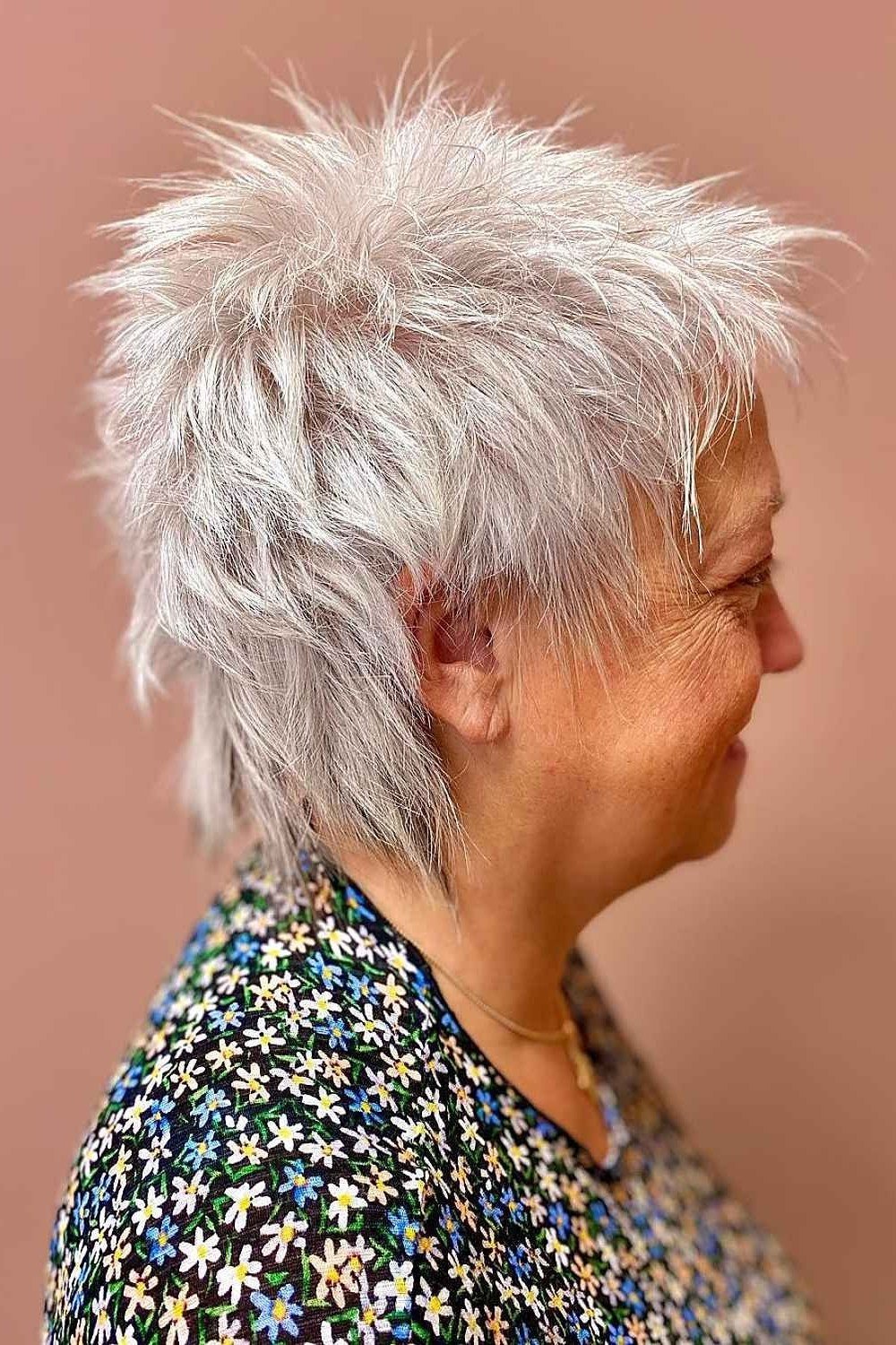 Short wolf cut for women over 60 - white spiky wolf, edgy layers, floral top, side view