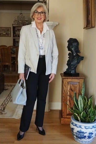White Blazer with Navy Trousers and Light Blue Bag - work outfit idea for women over 50
