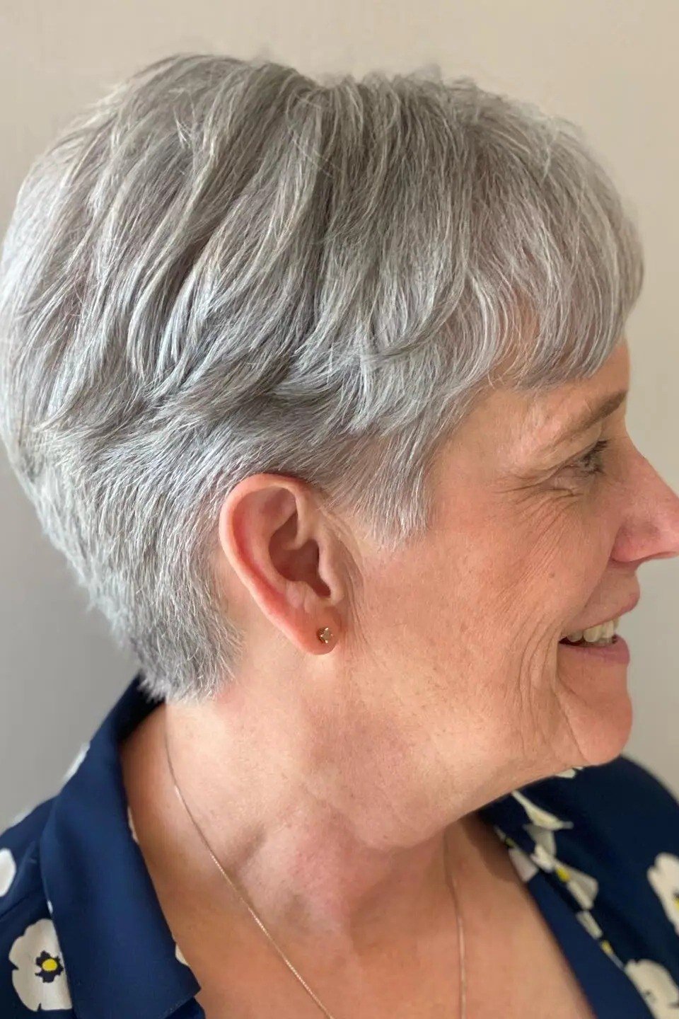 Gray pixie haircut side view for senior women, tapered wash-and-wear crop
