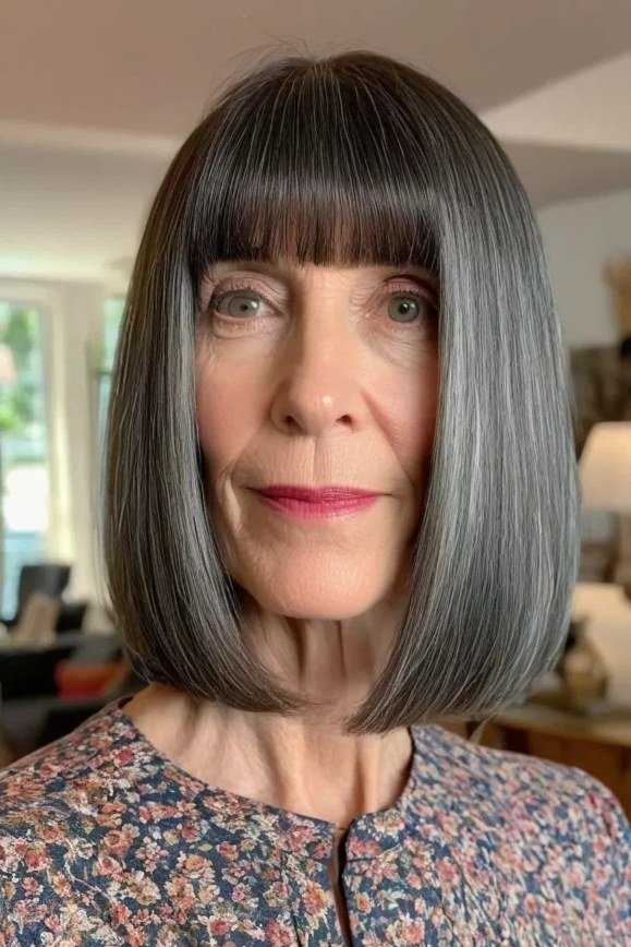 Dark blunt bob with straight bangs for older women, bold wash-and-wear style