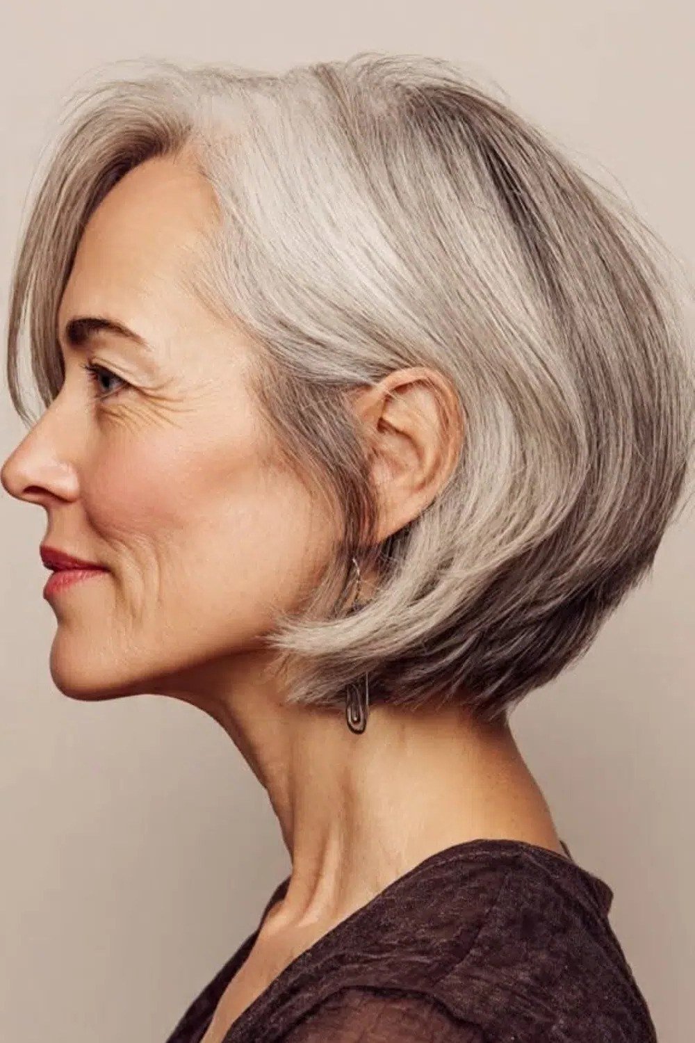Layered silver bob haircut side profile for older women, textured wash-and-wear style