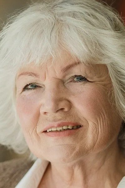 White curly bob haircut for women over 70, soft natural wash-and-wear curls
