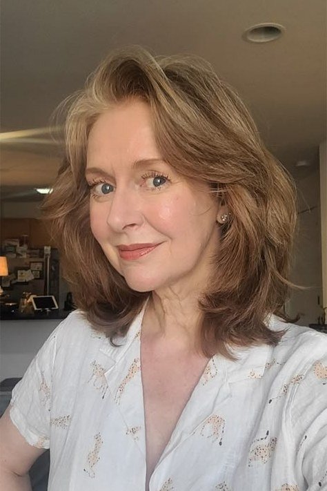 Honey-blonde shoulder-length waves for women over 70, soft wash-and-wear style