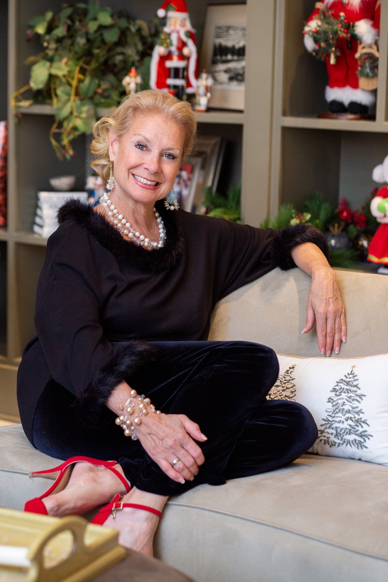 Black Velvet Top with Red Heels on the Sofa worn by older woman, black velvet top with red heels seated on sofa
