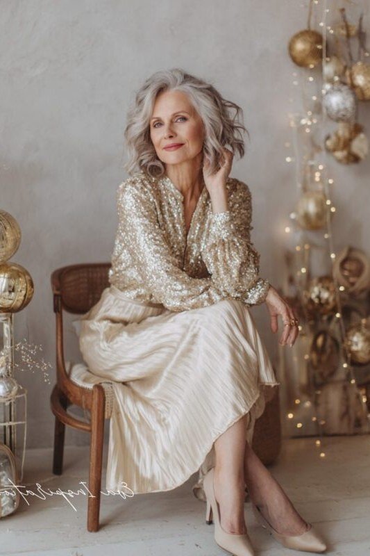 Gold Sequin Blouse with an Ivory Pleated Skirt worn by older woman, gold sequin blouse with ivory pleated skirt seated