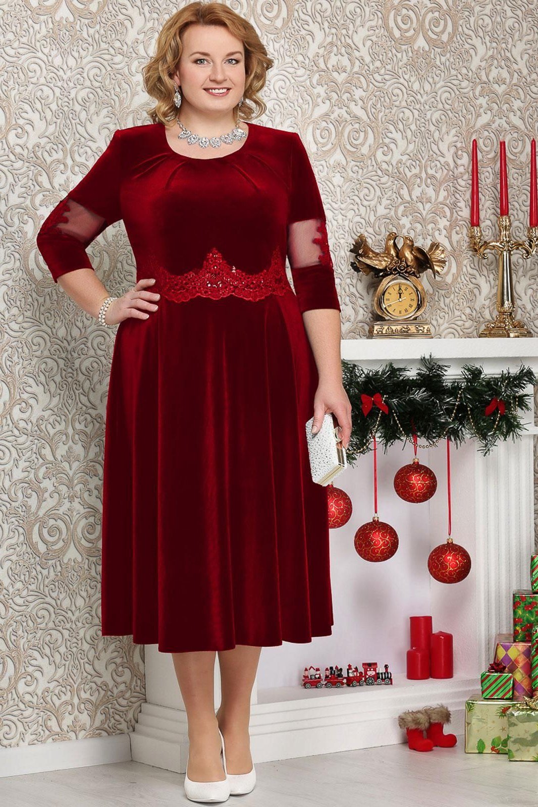 burgundy velvet dress with beaded waist by cozy fireplace