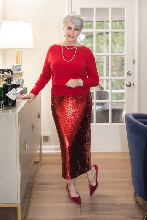 red knit top with red sequin midi skirt at holiday bar