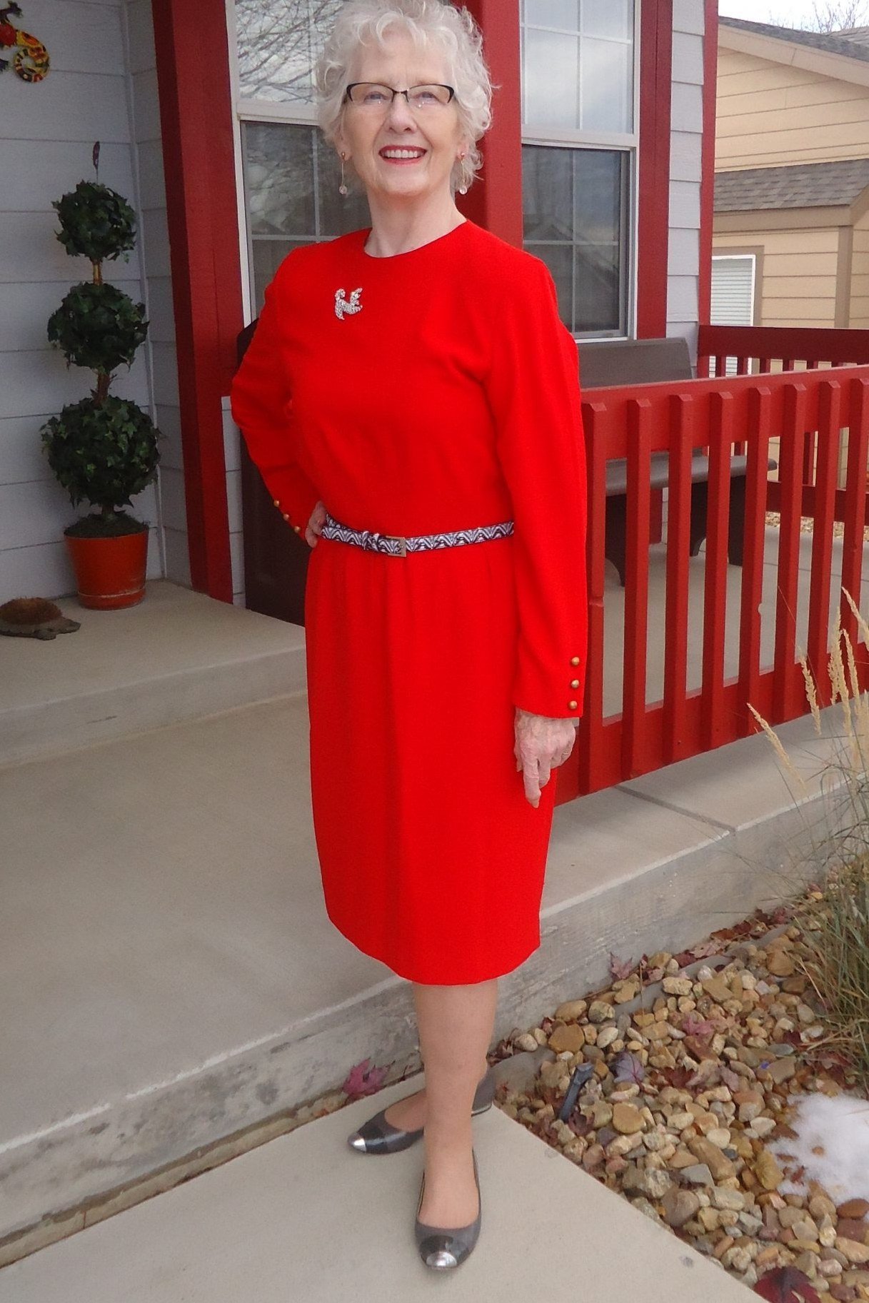 Red Knee-Length Dress with a Monogram worn by older woman, red knee-length dress with monogram on porch