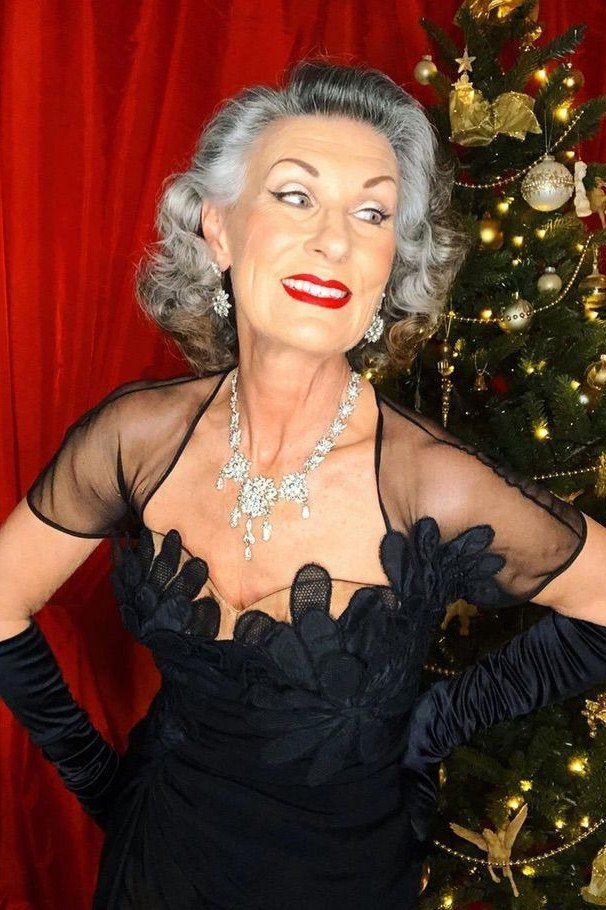 Black Dress with Sheer Sleeves and a Statement Necklace worn by older woman, black dress with sheer sleeves and statement nec